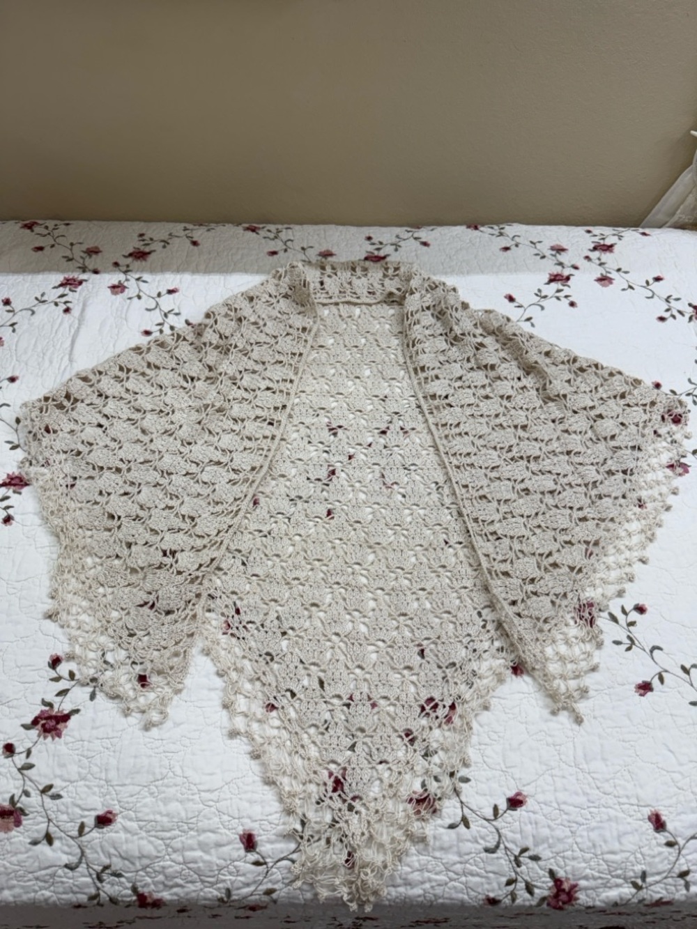 handmade cream-colored triangle shawl features intricate lacy crochet work
